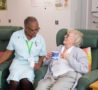 Female patient with a cup of tea, chats to healthcare assistant in the Evelyn Living Well Centre