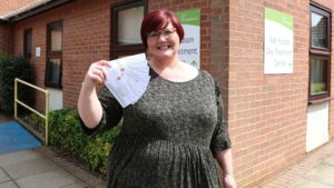 Female outside Alan Hudson Day Treatment Centre with raffle rickets