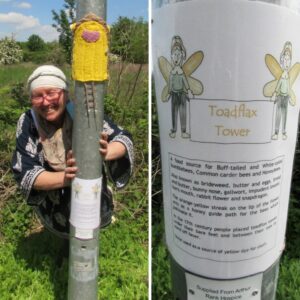 Lady with glasses and a white hat smiling near the lampost and yellow knitted door on the lamp post leading to Arthur Rank Hospice