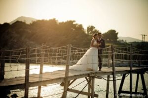 Lee and his wife in her Wedding Dress on a bridge in the sunset