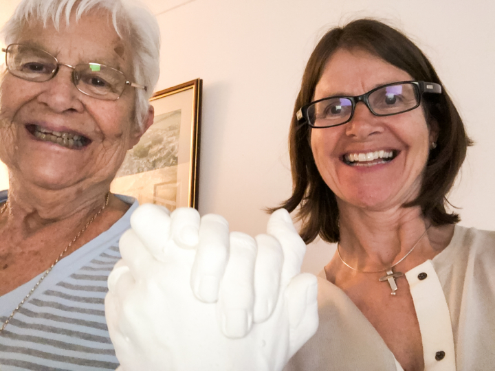 A mother and her daughter with their hand-cast