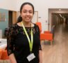 Young volunteer smiling in breakout area of Inpatient Unit