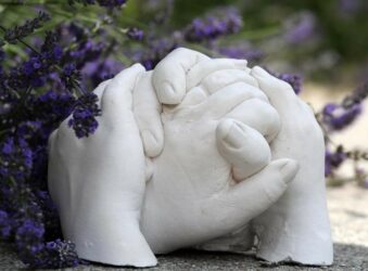 Plaster of Paris hand cast in garden with lavendar behind