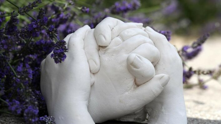 Plaster of Paris hand cast in garden with lavendar behind