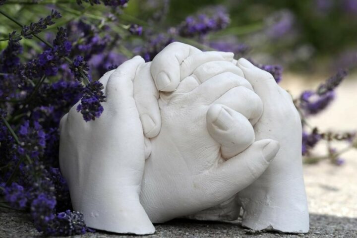 Plaster of Paris hand cast in garden with lavendar behind
