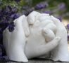 Plaster of Paris hand cast in garden with lavendar behind