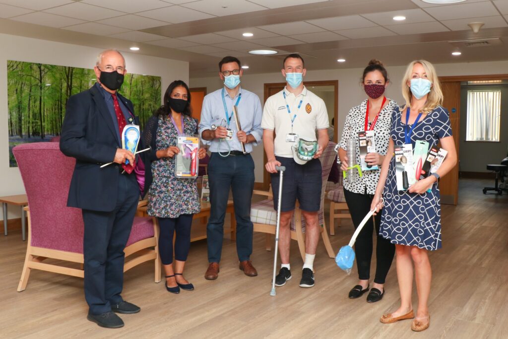 Some of the MND team, wearing masks and holding various equipment and aids