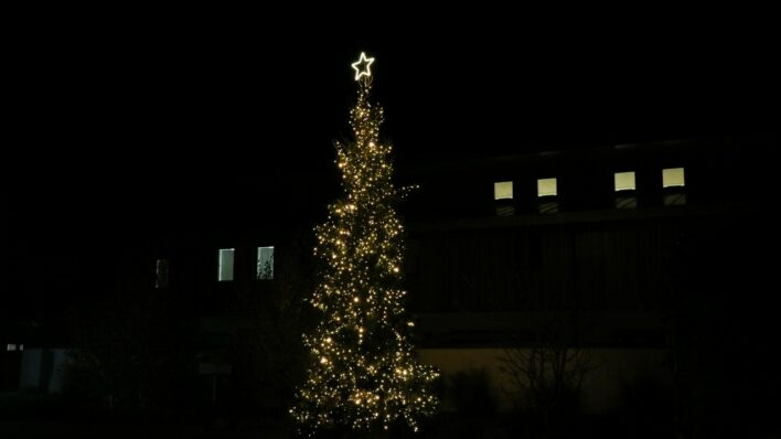 Christmas tree with yellow lights at night time