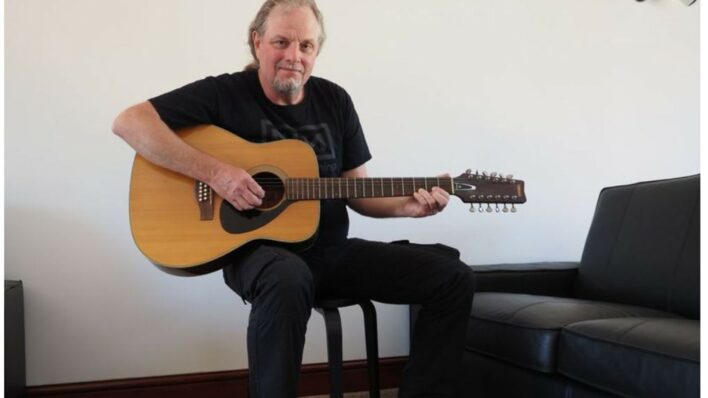 Mark Barrett holding Syd Barrett's guitar Image Cheffins PA Wire