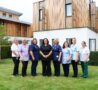 Eight members of the Inpatient Unit team, each wearing a different uniforms in the garden