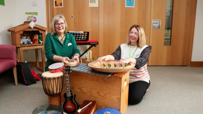Music Therapist and MA student from ARU, surrounded by all kinds of musical instruments