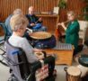 Three patients play various instruments as part of Music Therapy session in the Hospice's Sanctuary