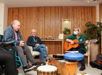 A patient talks to Helen the music therapist during a musical session