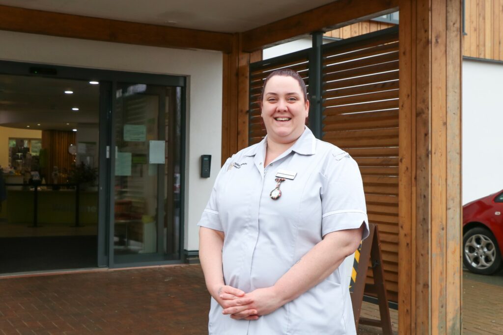 Kate Barry, Nursing Associate Trainee outside Arthur Rank Hospice Charity