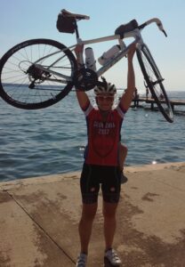 Female cyclist holding up bike 