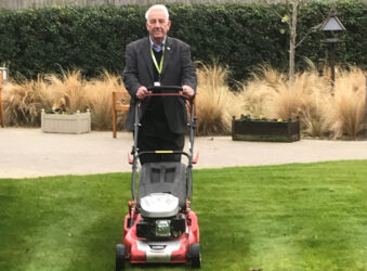 Mick, volunteer gardener cuts the grass at Arthur Rank Hospice