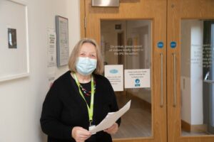 Female wearing a mask outside IPU doors at Arthur Rank Hospice Charity 