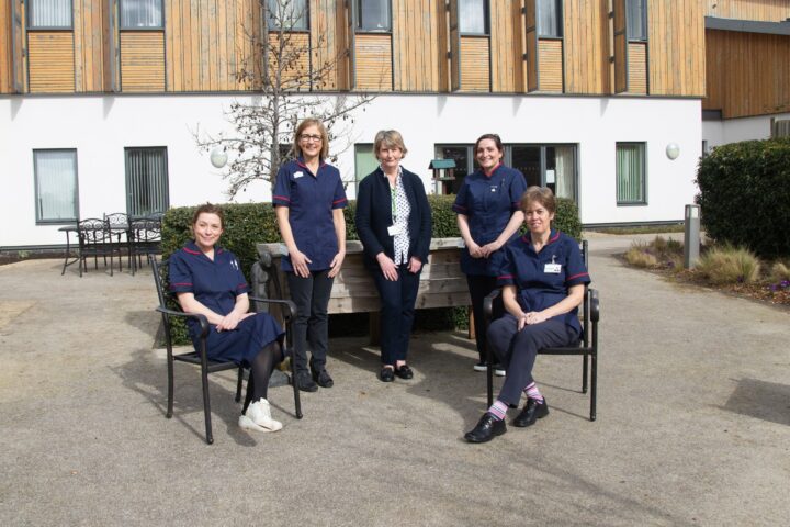 Female nurses in dark blue uniforms outside Arthur Rank Hospice