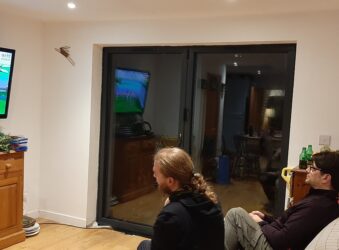 two males in black tops playing video a game