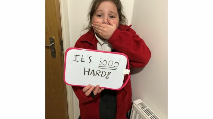Young girl with hand over mouth