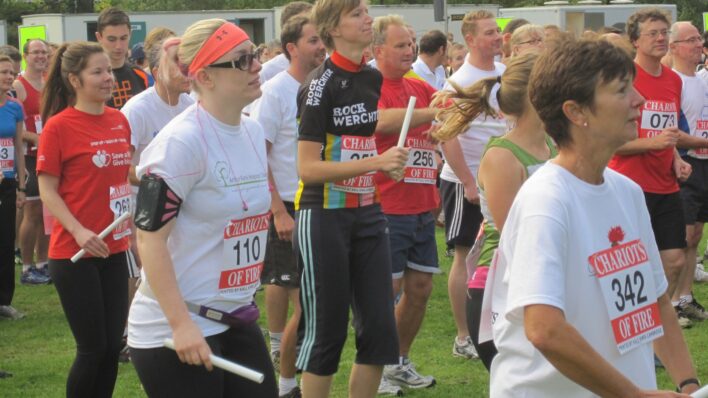 Runners warmingup for a race holding batons
