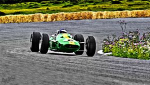 A green racing car on a track 