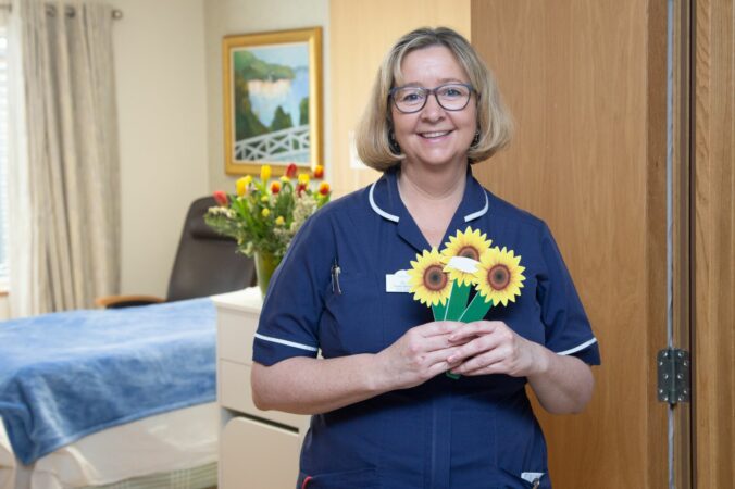 Nurse holding sunflower markers