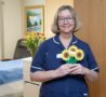 Nurse holding sunflower markers