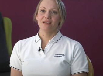 Female wearing a white uniform looking at the camera