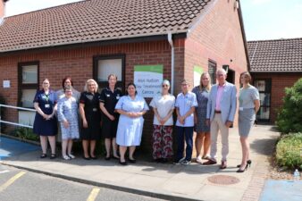 Nurses and men and women in a row outside the Alan Hudson Day Treatment Centre