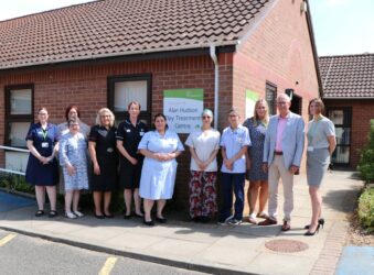 Nurses and men and women in a row outside the Alan Hudson Day Treatment Centre