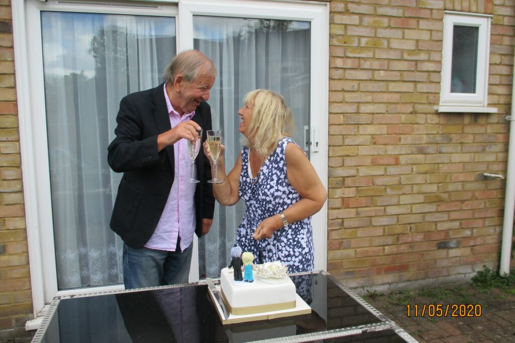 Male and female smiling at each other with champagne glasses