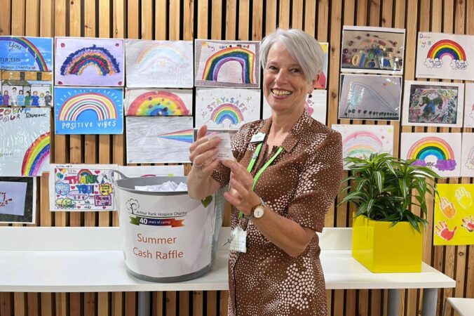 Sharon Allen CEO drawing a raffle ticket
