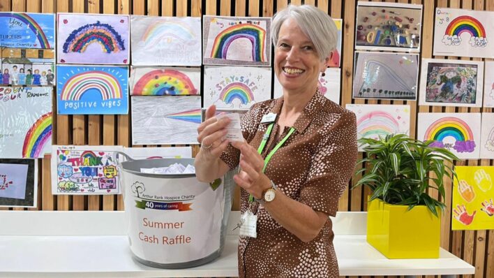Sharon Allen CEO drawing a raffle ticket