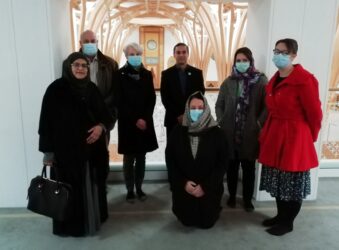 Males and females some wearing masks and hijabs