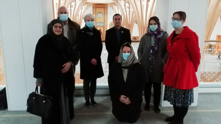 Males and females some wearing masks and hijabs