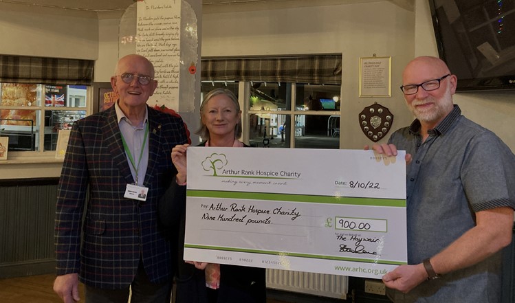 A male and female holding a large cheque