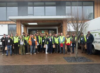a Group of volunteers outside Hospice in high Vis jackets