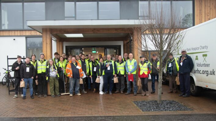 a Group of volunteers outside Hospice in high Vis jackets