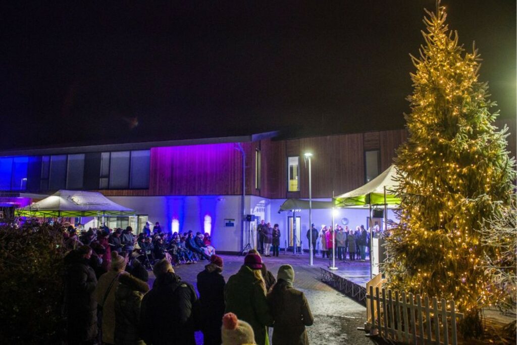 Christmas Tree and people sitting outside 