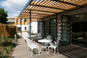 White tables and chairs on an outside terrace 