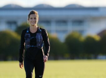 Female standing in front of a large building