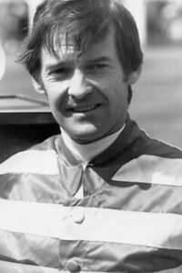 Black and white image of a male jockey 