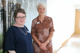 2 females with tree image behind