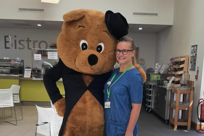 Arthur Bear and female staff member in Bistro