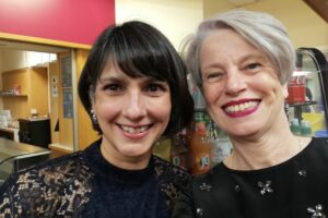 2 females smiling at the camera