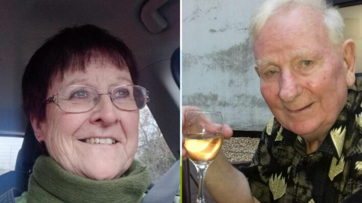 Female looking to right of camera and male holding wine glass looking at the camera