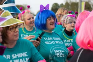 Female wearing a blue wig with other females