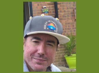 Male with cap looking at the camera