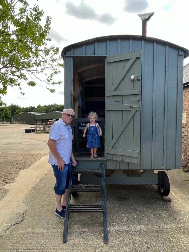 Man and little girl by wooden cart